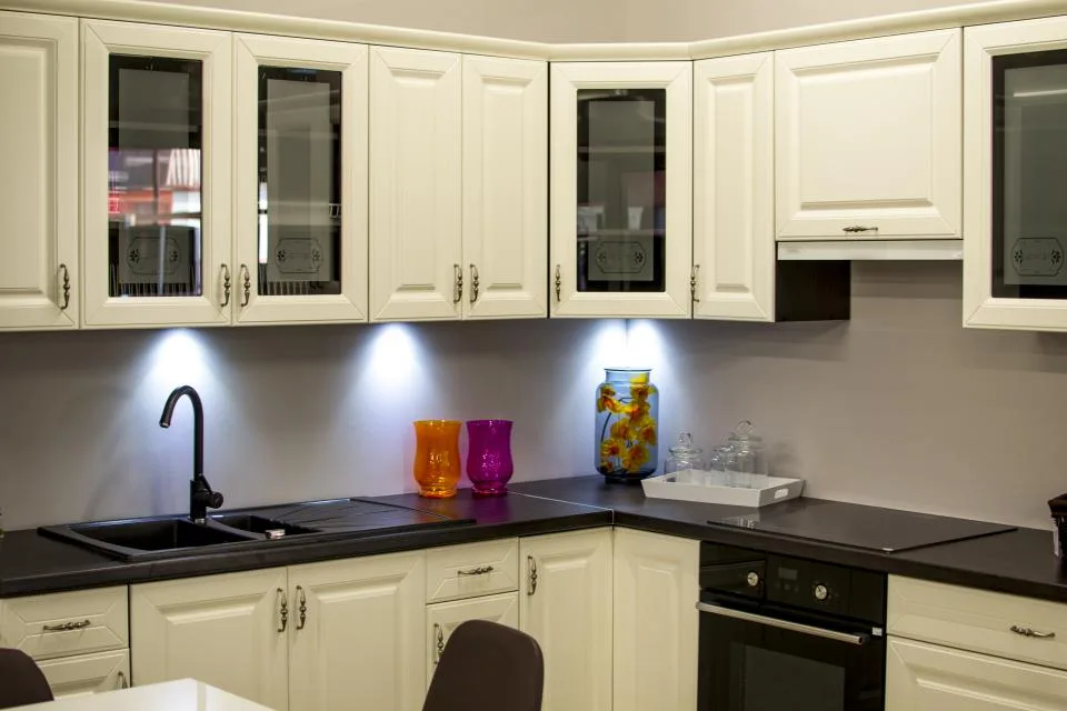 Refurbished kitchen with cream cabinetry and dark countertops
